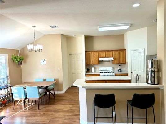 Chandelier, Dining room, Interior, Kitchen, Recessed Lighting, Stainless Steel Appliances, Wood Texture Flooring