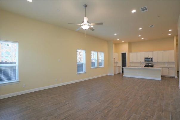 Empty room, Interior, Kitchen, Recessed Lighting, Stainless Steel Appliances, Wood Texture Flooring