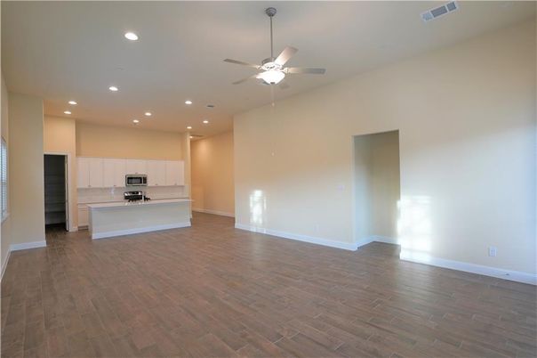 Empty room, Interior, Kitchen, Recessed Lighting, Stainless Steel Appliances, Wood Texture Flooring