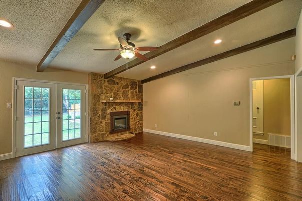 Empty room, Fireplace, Interior, Recessed Lighting, Stone Walls, Wooden Beams, Wood Texture Flooring