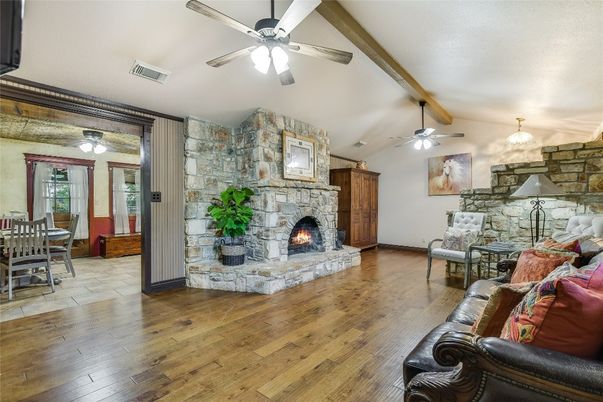 Chandelier, Dining room, Fireplace, Interior, Living room, Stone Walls, Wood Texture Flooring