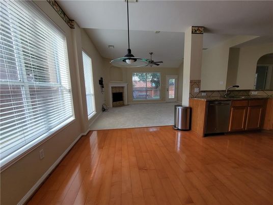 Empty room, Fireplace, Interior, Kitchen, Pendant Lights, Wood Texture Flooring