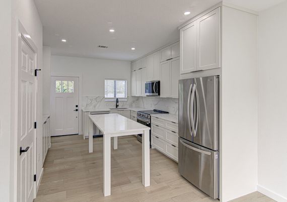 Interior, Kitchen, Marble Walls, Recessed Lighting, Stainless Steel Appliances, Wood Texture Flooring