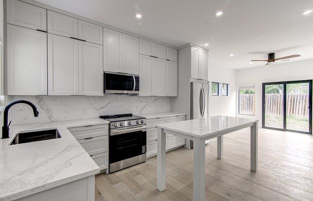 Interior, Kitchen, Marble Walls, Recessed Lighting, Stainless Steel Appliances, Wood Texture Flooring