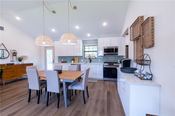 Dining room, Interior, Kitchen, Pendant Lights, Recessed Lighting, Stainless Steel Appliances, Wood Texture Flooring