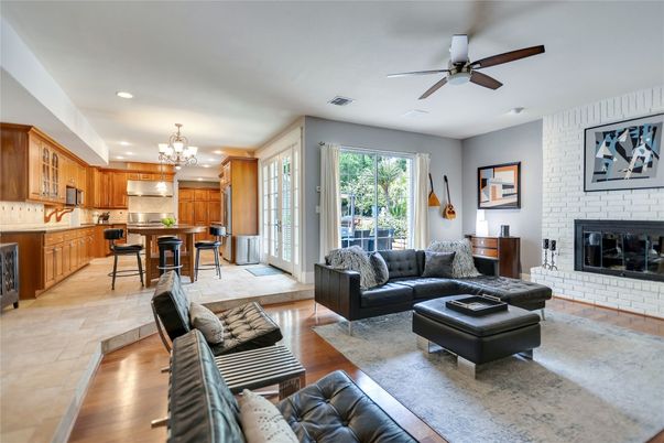 Chandelier, Dining room, Fireplace, Interior, Kitchen, Living room, Recessed Lighting, Stone Walls, Wood Texture Flooring