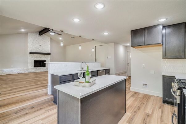 Fireplace, Interior, Kitchen, Pendant Lights, Recessed Lighting, Stone Walls, Wood Texture Flooring