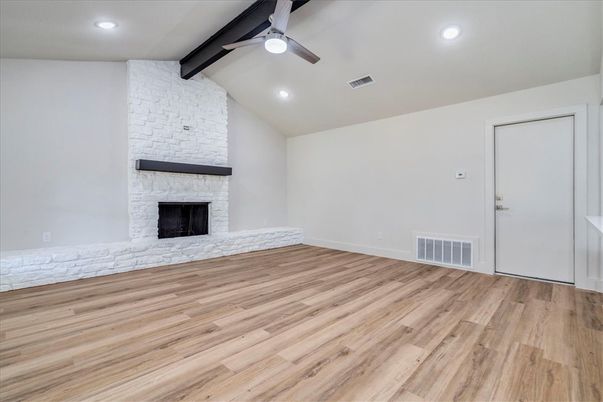 Empty room, Fireplace, Interior, Recessed Lighting, Stone Walls, Wood Texture Flooring