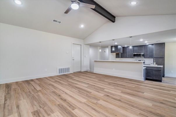 Empty room, Interior, Kitchen, Pendant Lights, Recessed Lighting, Stainless Steel Appliances, Wooden Beams, Wood Texture Flooring