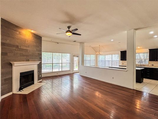 Chandelier, Empty room, Fireplace, Interior, Kitchen, Recessed Lighting, Wood Texture Flooring, Wooden Walls