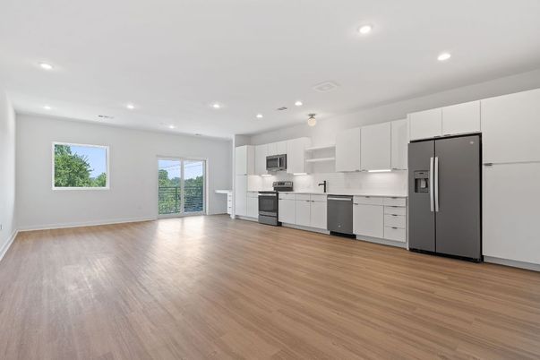 Empty room, Interior, Kitchen, Recessed Lighting, Stainless Steel Appliances, Wood Texture Flooring
