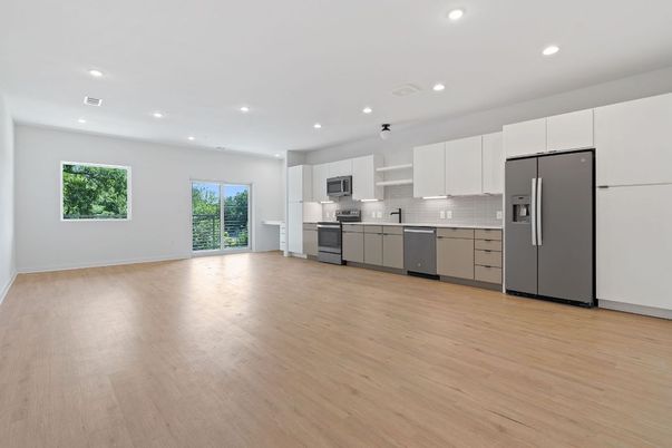 Empty room, Interior, Kitchen, Recessed Lighting, Stainless Steel Appliances, Wood Texture Flooring