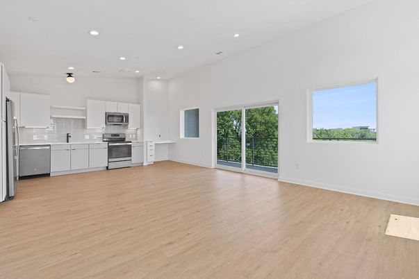 Empty room, Interior, Kitchen, Recessed Lighting, Stainless Steel Appliances, Wood Texture Flooring