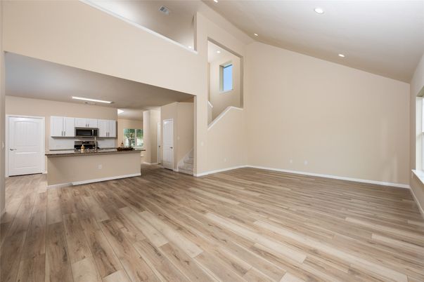 Empty room, Interior, Kitchen, Recessed Lighting, Stainless Steel Appliances, Wood Texture Flooring