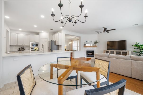 Chandelier, Dining room, Fireplace, Interior, Kitchen, Living room, Recessed Lighting, Stainless Steel Appliances, Wood Texture Flooring
