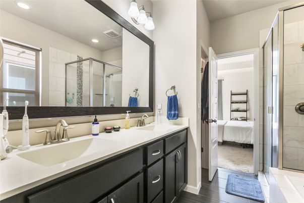 Bathroom, Bedroom, Dual Sink Vanities, Glass Shower, Interior, Marble Walls, Recessed Lighting, Wood Texture Flooring