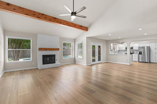 Empty room, Fireplace, Interior, Kitchen, Recessed Lighting, Stainless Steel Appliances, Wooden Beams, Wood Texture Flooring