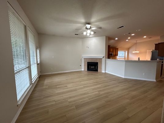 Chandelier, Empty room, Fireplace, Interior, Kitchen, Pendant Lights, Recessed Lighting, Wood Texture Flooring