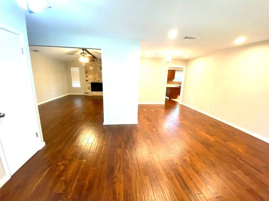 Empty room, Fireplace, Interior, Recessed Lighting, Stone Walls, Wood Texture Flooring