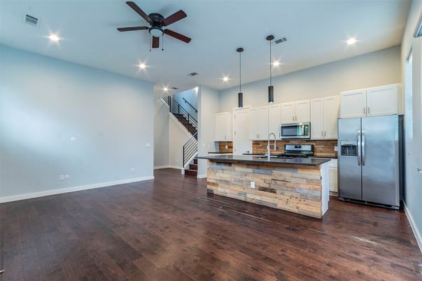 Empty room, Interior, Kitchen, Pendant Lights, Recessed Lighting, Stainless Steel Appliances, Wood Texture Flooring