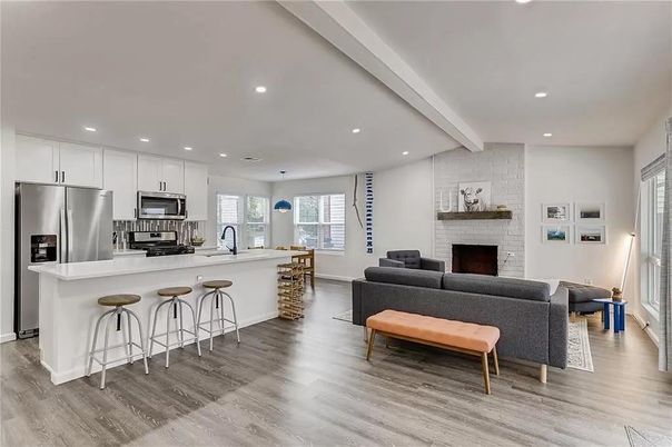 Fireplace, Interior, Kitchen, Living room, Pendant Lights, Recessed Lighting, Stainless Steel Appliances, Stone Walls, Wood Texture Flooring
