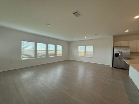 Empty room, Interior, Kitchen, Recessed Lighting, Stainless Steel Appliances, Wood Texture Flooring