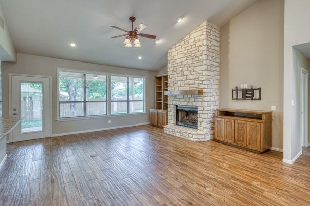 Empty room, Fireplace, Interior, Recessed Lighting, Stone Walls, Wood Texture Flooring