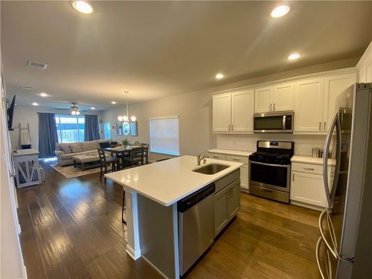 Chandelier, Dining room, Interior, Kitchen, Living room, Pendant Lights, Recessed Lighting, Stainless Steel Appliances, Wood Texture Flooring