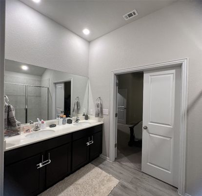 Bathroom, Dual Sink Vanities, Glass Shower, Interior, Recessed Lighting, Wood Texture Flooring