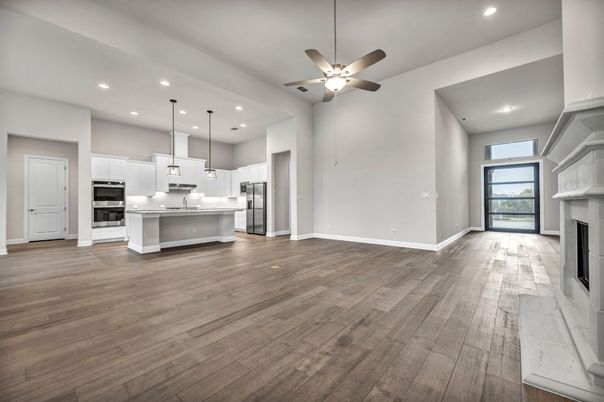 Empty room, Fireplace, Interior, Kitchen, Pendant Lights, Recessed Lighting, Stainless Steel Appliances, Wood Texture Flooring