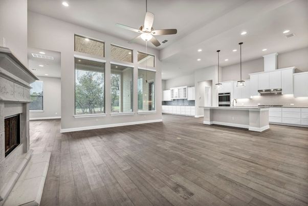 Empty room, Fireplace, Interior, Kitchen, Pendant Lights, Recessed Lighting, Stainless Steel Appliances, Wood Texture Flooring