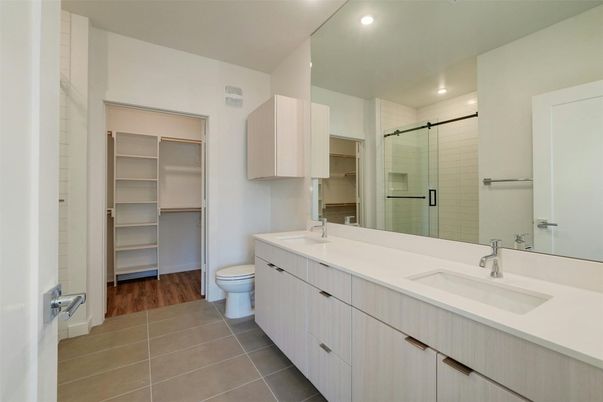Bathroom, Dual Sink Vanities, Glass Shower, Interior, Recessed Lighting, Walk-in Closets, Wood Texture Flooring