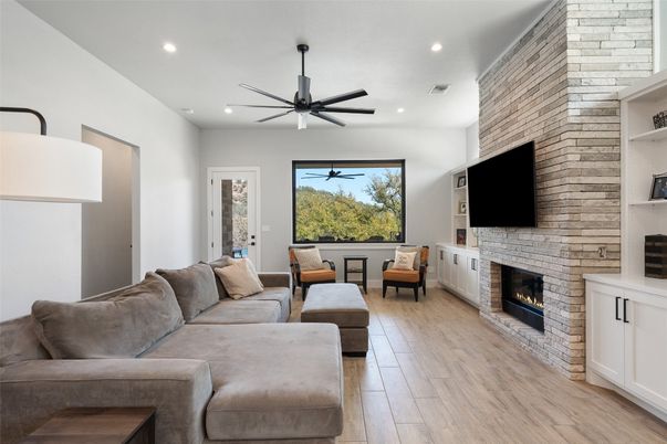 Fireplace, Interior, Living room, Recessed Lighting, Stone Walls, Wood Texture Flooring