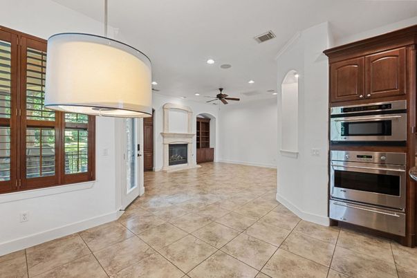 Empty room, Fireplace, Interior, Kitchen, Pendant Lights, Recessed Lighting, Stainless Steel Appliances