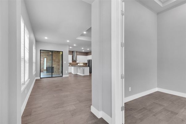 Empty room, Interior, Kitchen, Recessed Lighting, Stainless Steel Appliances, Wood Texture Flooring