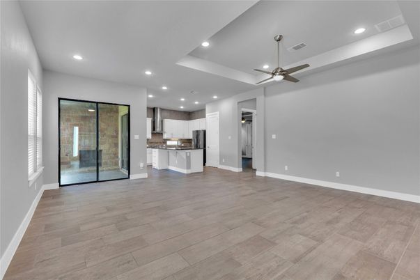 Empty room, Interior, Kitchen, Recessed Lighting, Stainless Steel Appliances, Wood Texture Flooring