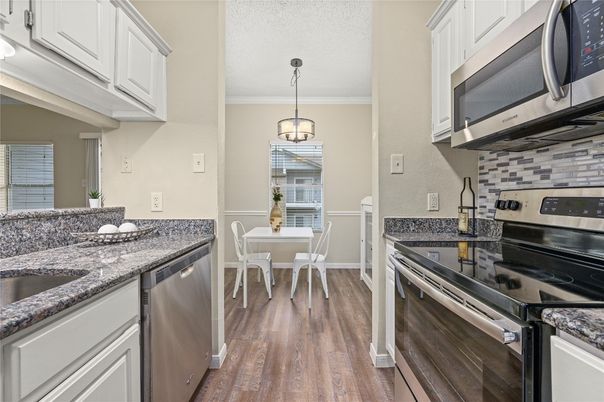 Dining room, Interior, Kitchen, Pendant Lights, Stainless Steel Appliances, Wood Texture Flooring