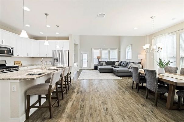 Chandelier, Dining room, Interior, Kitchen, Living room, Pendant Lights, Recessed Lighting, Stainless Steel Appliances, Wood Texture Flooring