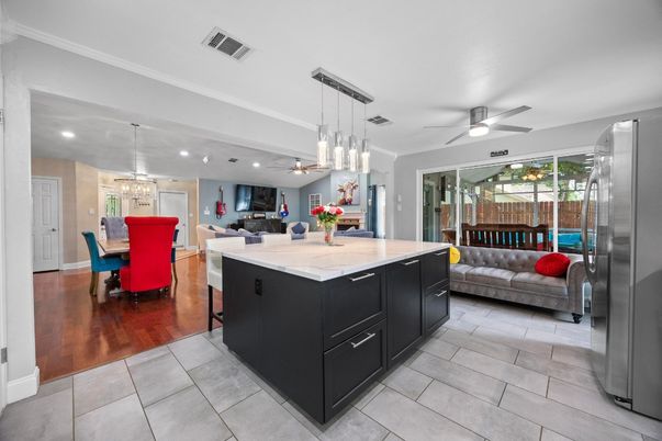 Chandelier, Dining room, Interior, Kitchen, Living room, Pendant Lights, Recessed Lighting, Stainless Steel Appliances, Wood Texture Flooring