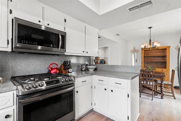 Chandelier, Dining room, Interior, Kitchen, Pendant Lights, Stainless Steel Appliances, Wood Texture Flooring