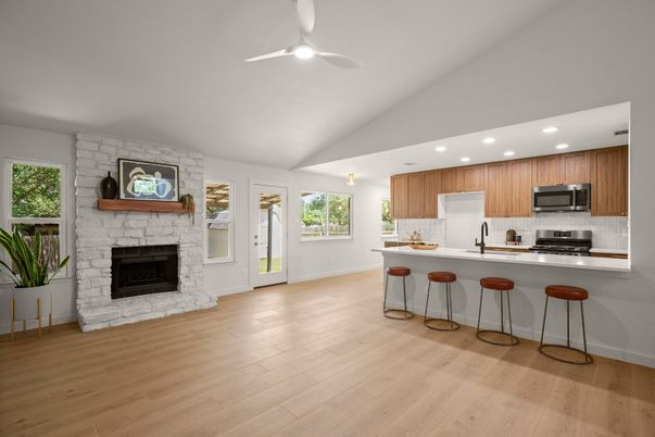 Fireplace, Interior, Kitchen, Recessed Lighting, Stainless Steel Appliances, Stone Walls, Wood Texture Flooring