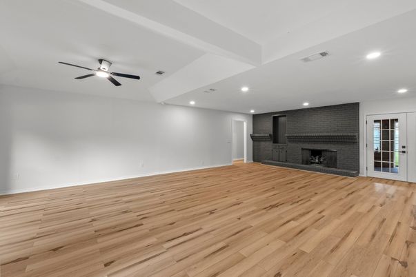 Empty room, Fireplace, Interior, Recessed Lighting, Stone Walls, Wood Texture Flooring