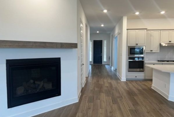 Fireplace, Interior, Kitchen, Recessed Lighting, Stainless Steel Appliances, Wood Texture Flooring
