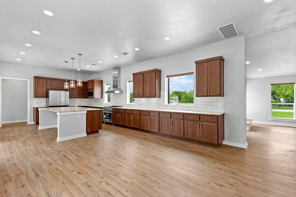 Empty room, Interior, Kitchen, Pendant Lights, Recessed Lighting, Stainless Steel Appliances, Wood Texture Flooring