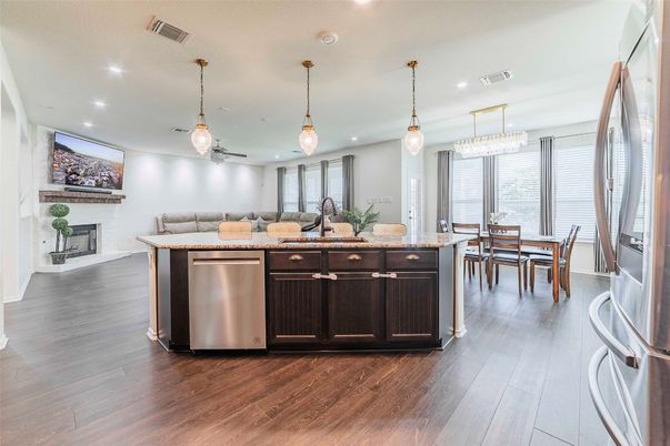 Chandelier, Dining room, Fireplace, Interior, Kitchen, Pendant Lights, Recessed Lighting, Stainless Steel Appliances, Wood Texture Flooring