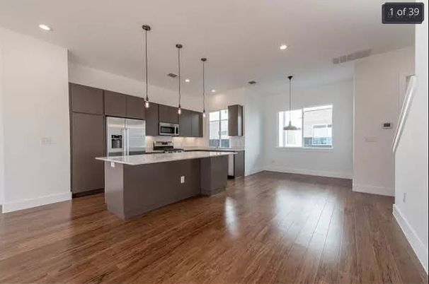 Empty room, Interior, Kitchen, Pendant Lights, Recessed Lighting, Stainless Steel Appliances, Wood Texture Flooring