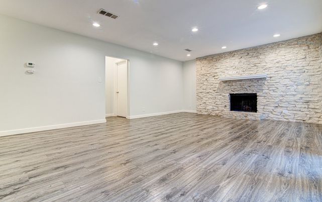 Empty room, Fireplace, Interior, Recessed Lighting, Stone Walls, Wood Texture Flooring