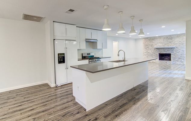 Fireplace, Interior, Kitchen, Pendant Lights, Recessed Lighting, Stainless Steel Appliances, Stone Walls, Wood Texture Flooring