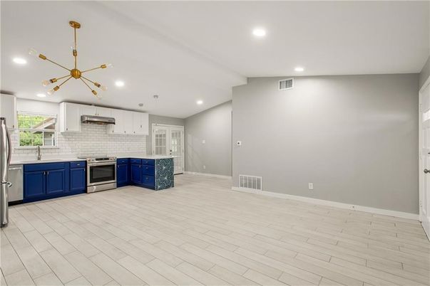 Empty room, Interior, Kitchen, Pendant Lights, Recessed Lighting, Stainless Steel Appliances, Wood Texture Flooring