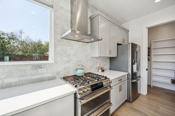Interior, Kitchen, Marble Walls, Recessed Lighting, Stainless Steel Appliances, Wood Texture Flooring